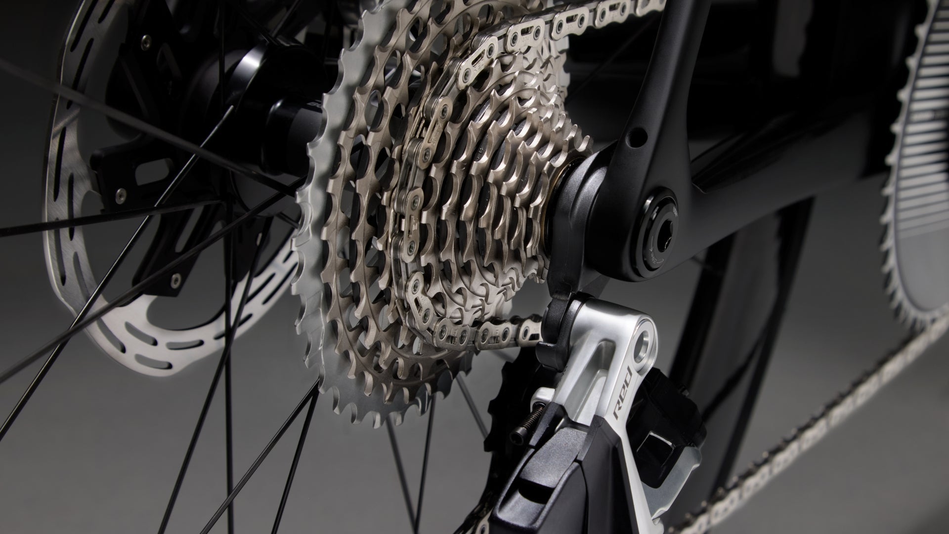 Close-up of a bicycle gear system with chain and sprockets on a dark background