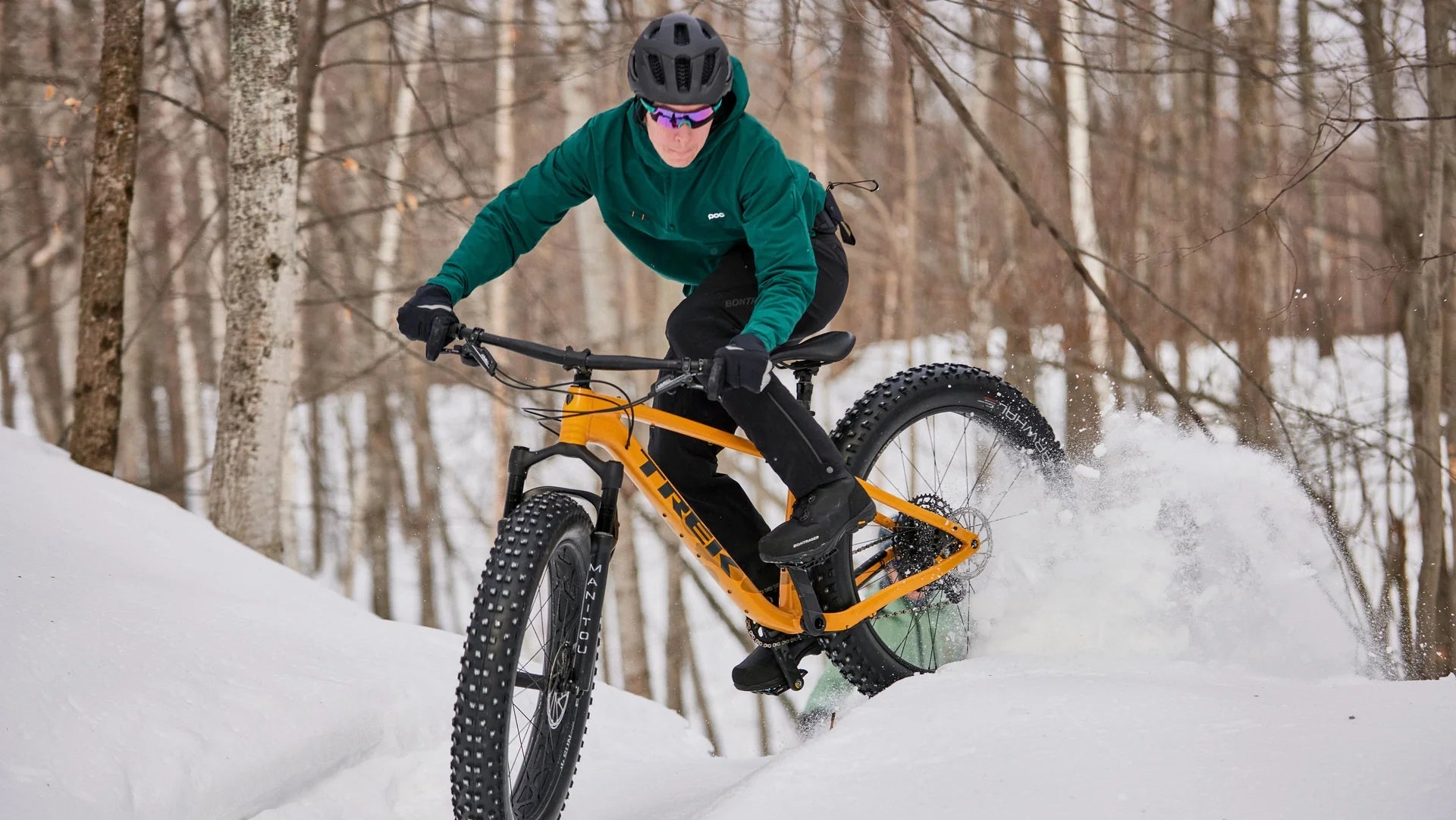 Person riding a fat bike through a snowy landscape