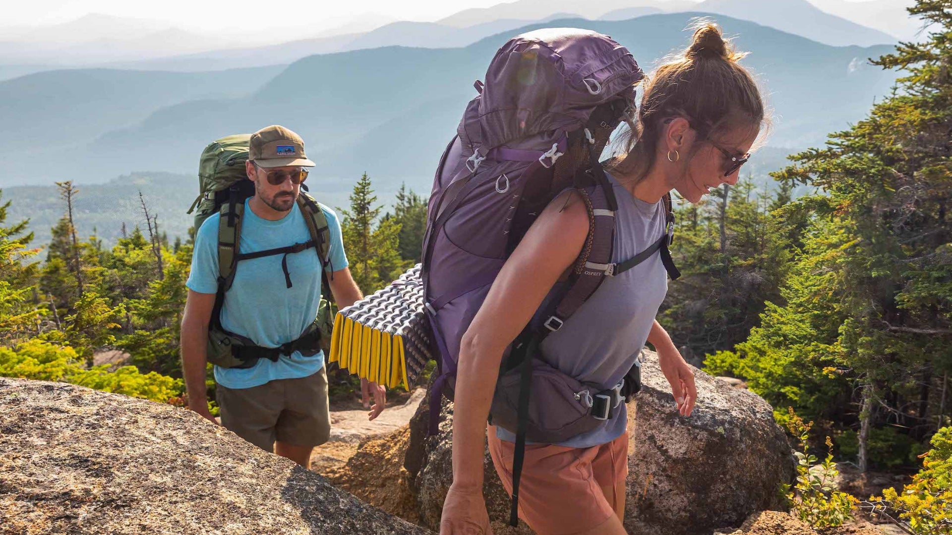 Two hikers with backpacks on a mountain trail