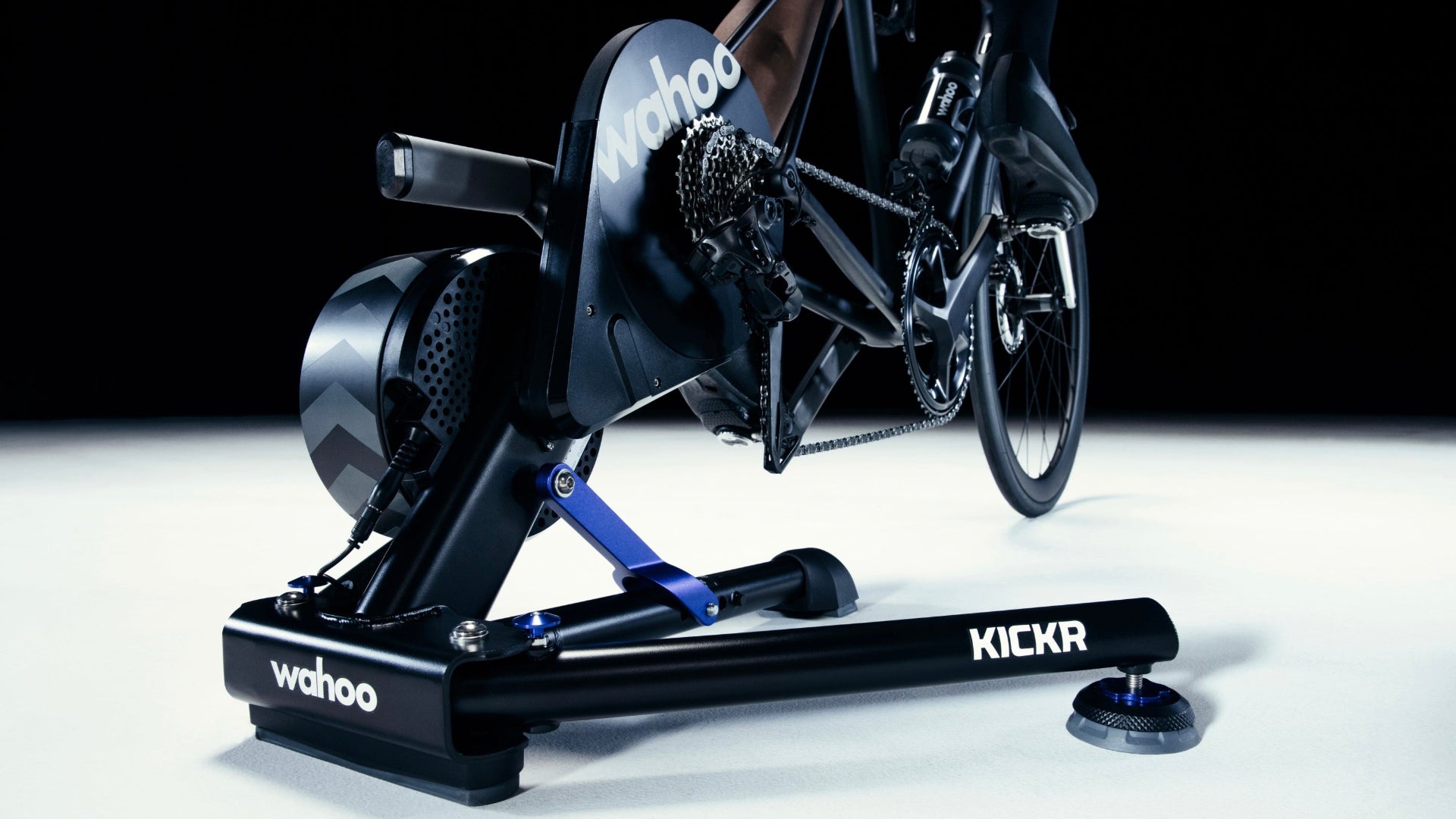Wahoo KICKR indoor cycling trainer with a bike on a black background