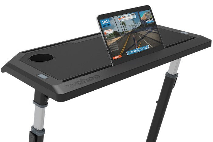 Black adjustable desk with a tablet on a white background