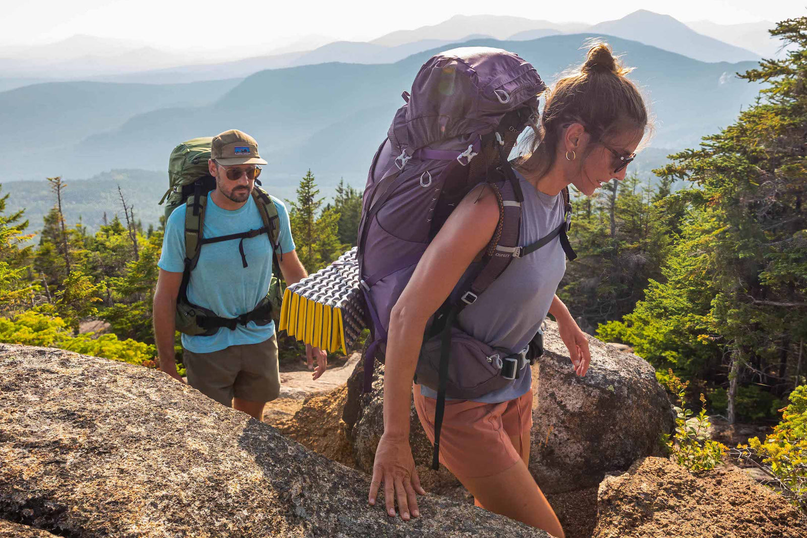Two hikers with backpacks on a mountain trail