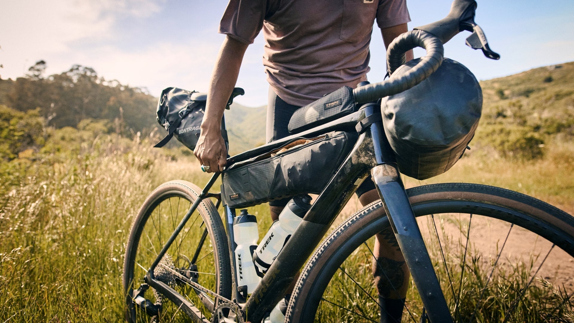 Person with a bicycle unzipping a frame pack